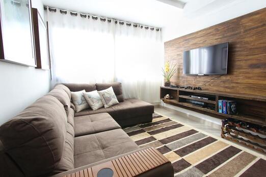 Living room with TV mounted on floating wood entertainment console